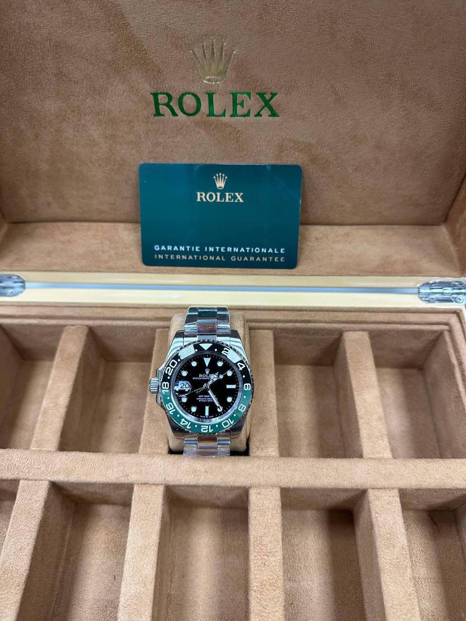 Rolex GMT-Master II Watch, Model due to its Distinctive Green and Black Bezel and Crown Placement.