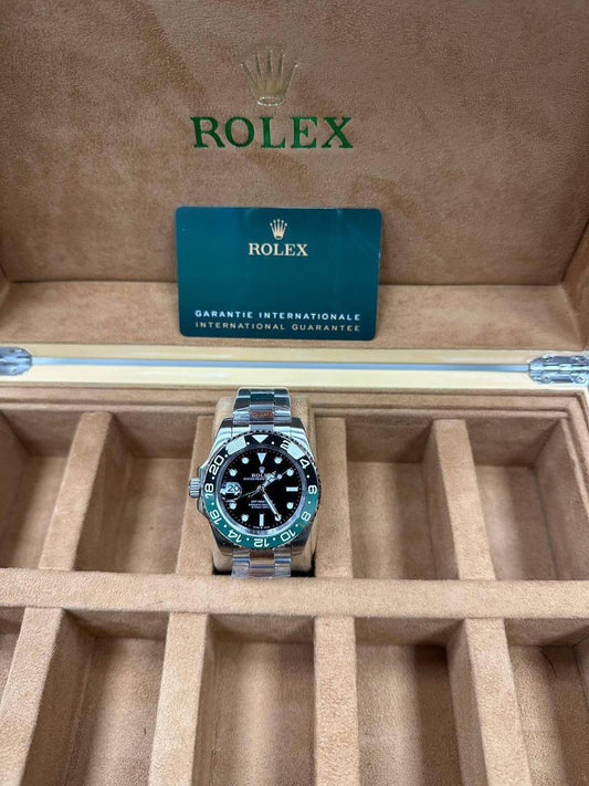 Rolex GMT-Master II Watch, Model due to its Distinctive Green and Black Bezel and Crown Placement.